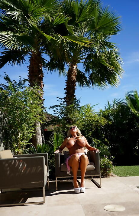 Tempting american housewife Sandra Otterson in nice skirt shows big boobs and ass near the pool